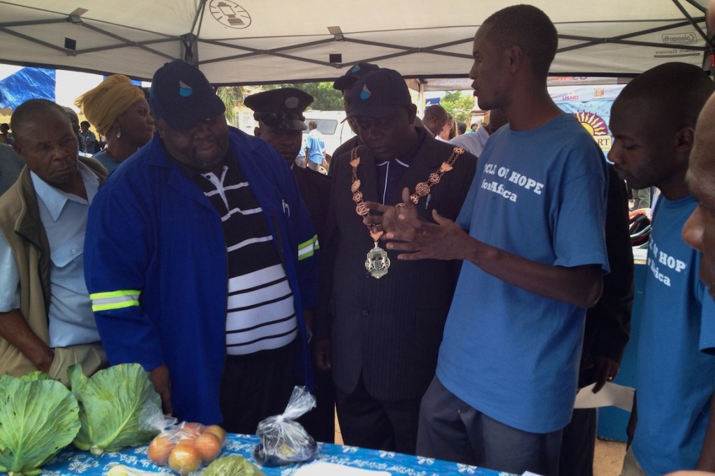 Robinson Mufumbilwa talks about Seeds of Hope’s programs to the Mayor and Manager of the water company.